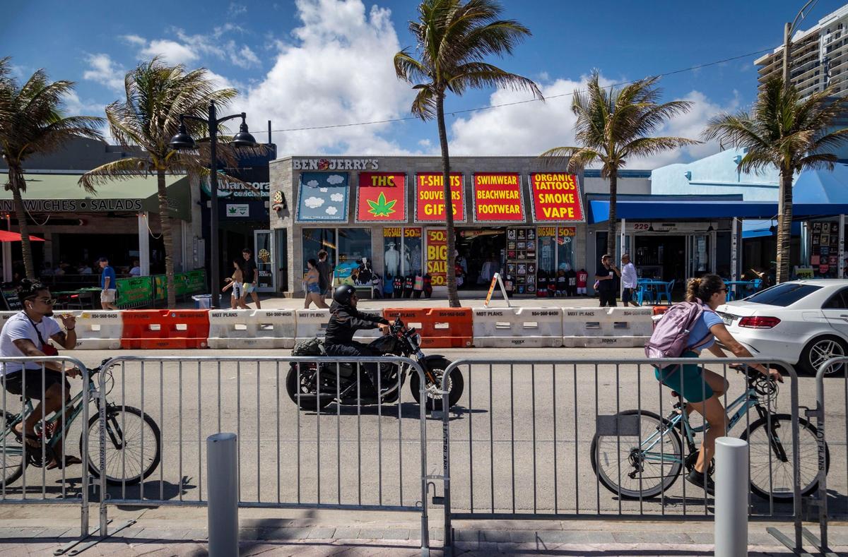 People enjoy a beautiful day in Fort Lauderdale Beach as they ride and walk by barricades placed on both sides of A1A as a means of crowd control on Feb. 28, 2024.