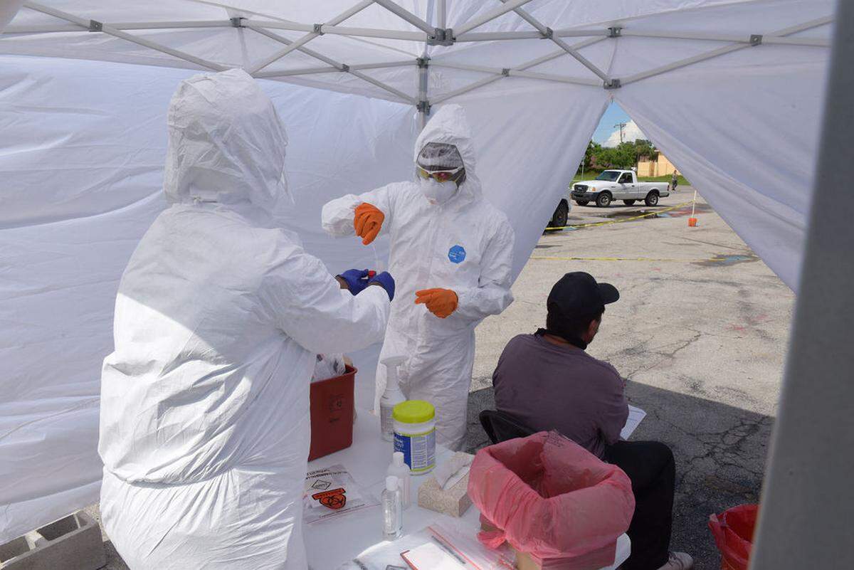 Florida Department of Health for Collier County nurses Casey Owens and Sonny Pierre finish conducting a free COVD-19 test during the health clinic on Thursday, June 11, 2020, in Immokalee. Doctors Without Borders (Médecins Sans Frontières) arrived in the farming community in May and opened mobile clinics targeted at the region’s 15,000 to 20,000 migrant farmworkers.