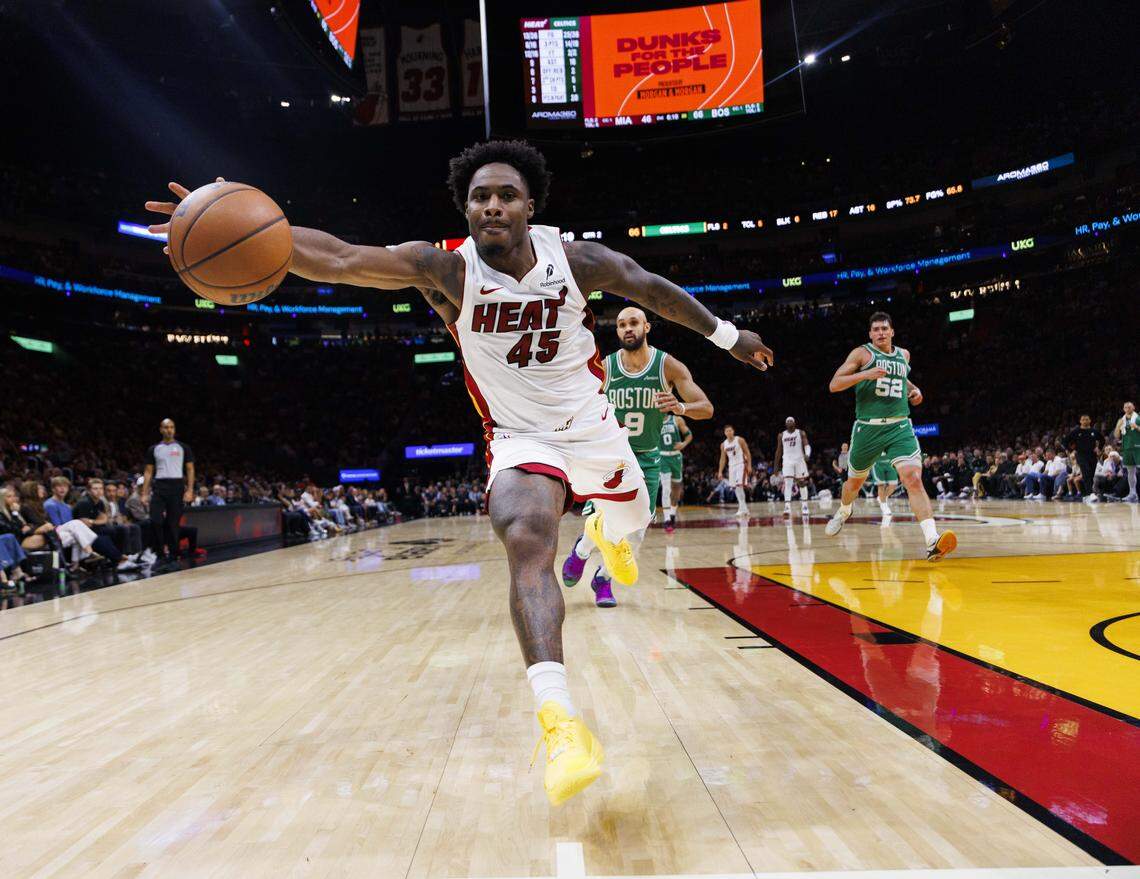 Miami Heat guard Davion Mitchell (45) reaches to save the ball during the first half of a game against the Boston Celtics on Wednesday, April 1, 2026, at the Kaseya Center in downtown Miami, Fla. 