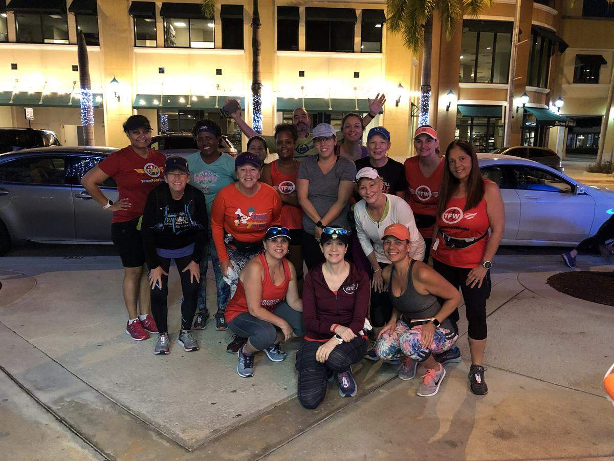 The 1:1 running group from Team Footworks before they headed out on their 8-mile run on Saturday, Jan. 19, the last long run before Sunday’s Miami Half Marathon. Betty Perez, one of the two leaders, is kneeling in the front center; Teri Patton, standing on the right in the second row, is the co-leader.