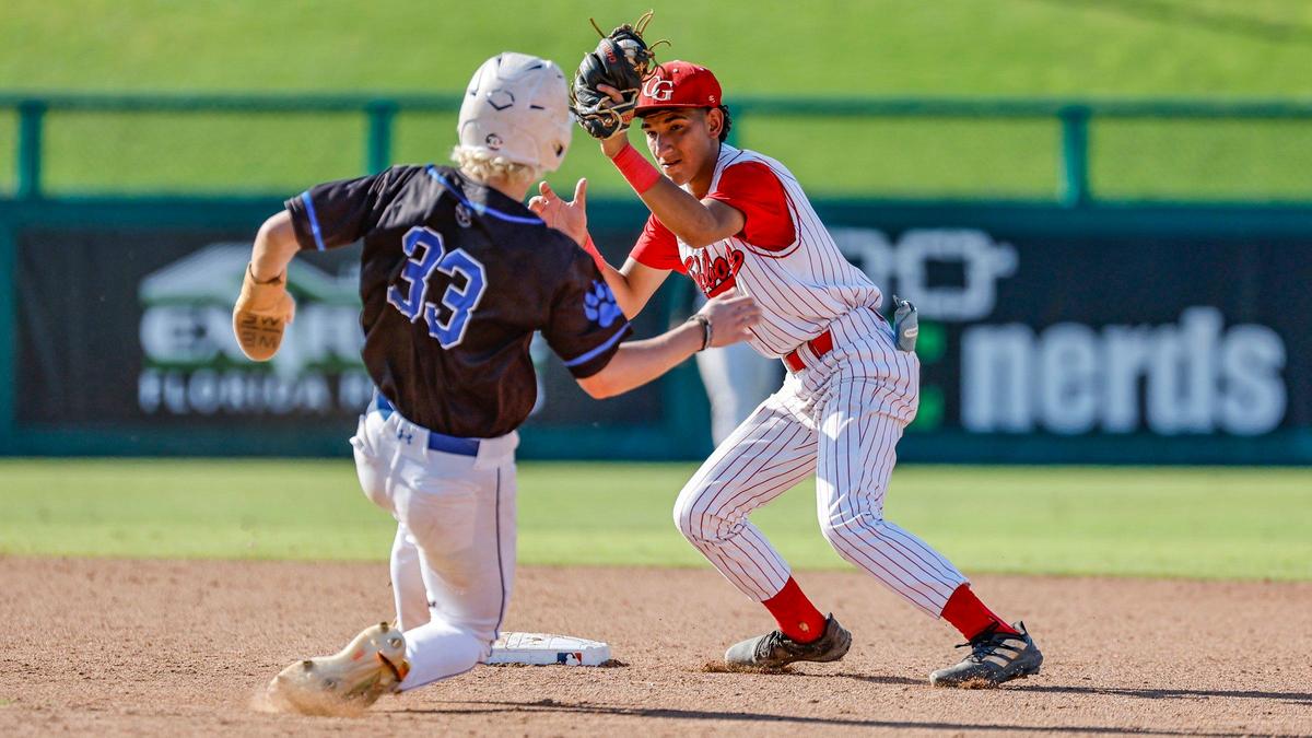 Cardinal Gibbons Chiefs Victor Norori (23) tags out Mulberry Panthers Cooper Wright (33) at second base in the fifth inning during the FHSAA Baseball Class 4A State Semifinal at Hammond Stadium in Fort Myers, Florida on Tuesday, May 21, 2024.