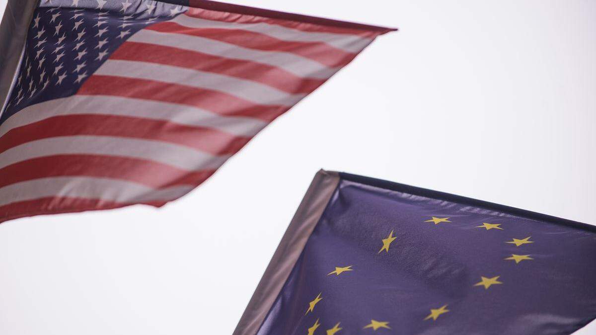 Flags of the United States and the European Union fly together.