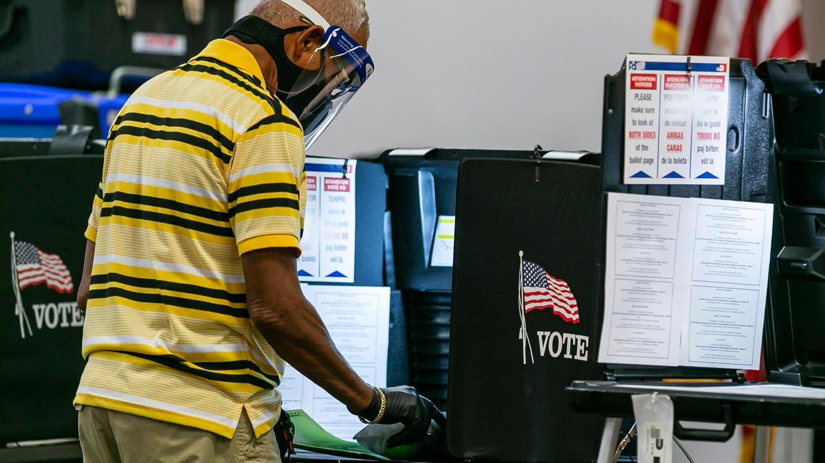 A man casts his vote at the North Dade Regional Library in Miami Gardens on Monday, Aug. 3, the first day of early voting for the Aug. 18 primary.