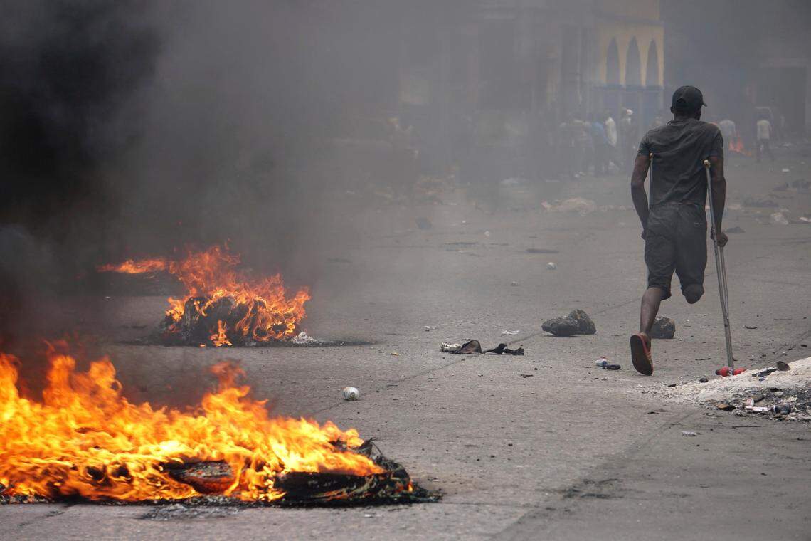A protester passes burning tires during a demonstration to demand the resignation of President Jovenel Moise in Port-au-Prince, Haiti, Monday, June 10, 2019. Opposition leaders in Haiti launched a two-day strike that paralyzed the country’s capital amid another day of protests.