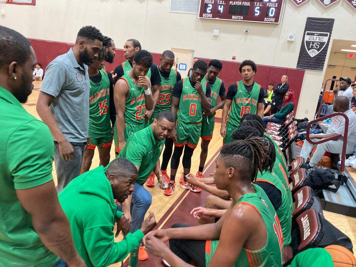 Ely head coach Henry McNabb gives his players a pep talk during a timeout in Thursday’s Region 4-6A final at Pembroke Pines Charter School.
