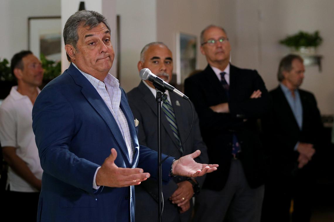 Felipe Valls Jr., owner of the iconic Cuban restaurant Versailles, reacts as he joined a group of elected officials from Miami-Dade County and Miami Beach, including Miami Beach Mayor Dan Gelber (far right) and Manager Jimmy Morales, during the announcement at Joe’s Stone Crab restaurant of a countywide closure on dine-in restaurants, bars and clubs, gyms and entertainment venues beginning Wednesday March 18th, due to the pandemic coronavirus Covid-19 crisis.