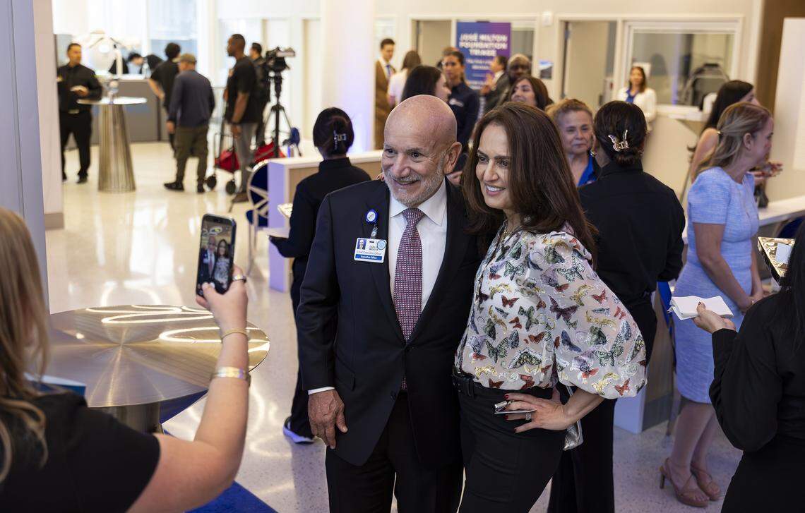 Carlos Migoya, outgoing Jackson Health System chief executive officer, takes a photo with Mojdeh Khaghan during a preview event of a new emergency room at Jackson Memorial Hospital on Thursday, April 16, 2026, in Miami, Fla.