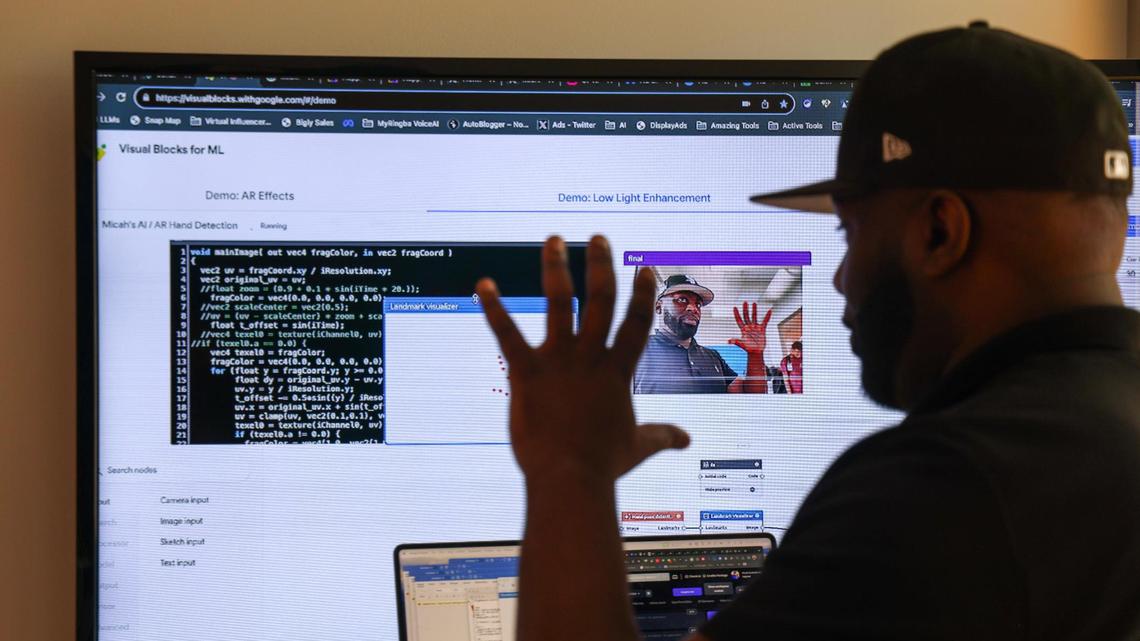 Micah Berkley, a Black tech entrepreneur, is using the power of AI to map his hand to create a digital image of himself that can be used in branding products, which he developed from his Edgewater office in Miami, Florida, on Thursday, November 16, 2023.
