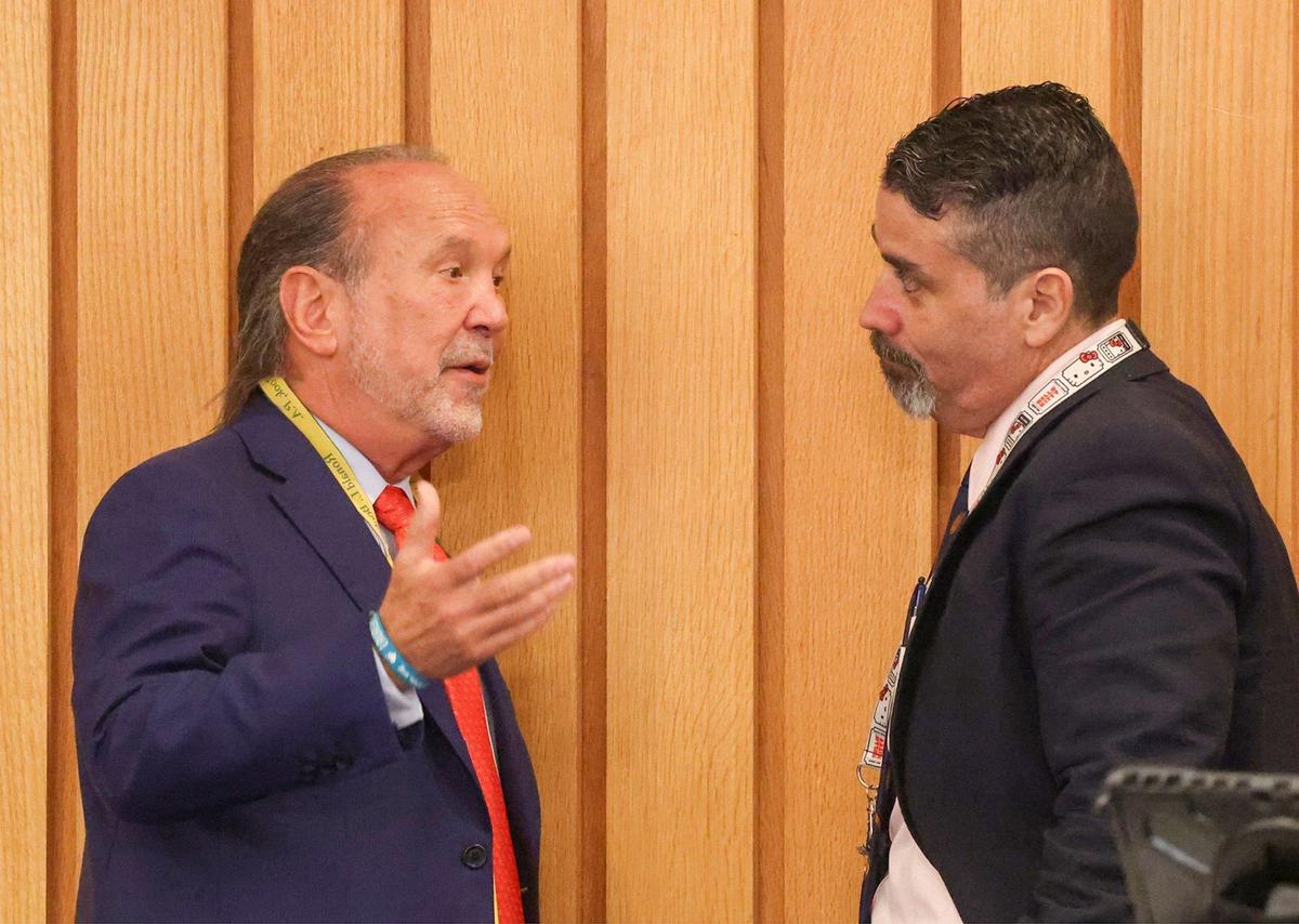 Ron Book, left, speaks with Anthony Escarra, an aide to Miami-Dade Commissioner Raquel Regalado, right, during a commission meeting on Wednesday, Sept. 4, 2024, at the Stephen P. Clark Center in Miami. The county voted to purchase a La Quinta hotel in Cutler Bay to house senior citizens transitioning out of homelessness. 