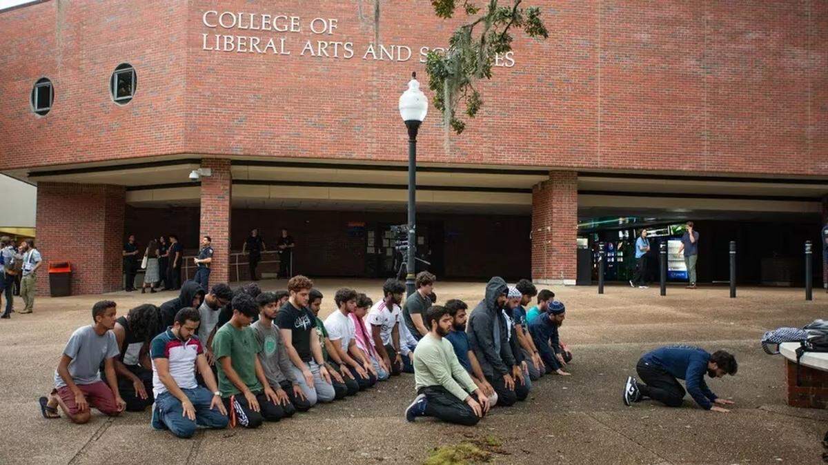 Students gather for prayer at the University of Florida’s Turlington Hall after a teach-in organized by the Students for Justice in Palestine to discuss the Israel-Hamas war on Thursday, Oct. 12, 2023, in Gainesville. The DeSantis administration now says the group must be “deactivated” on Florida’s public university campuses. [ LUIS SANTANA | Times ]