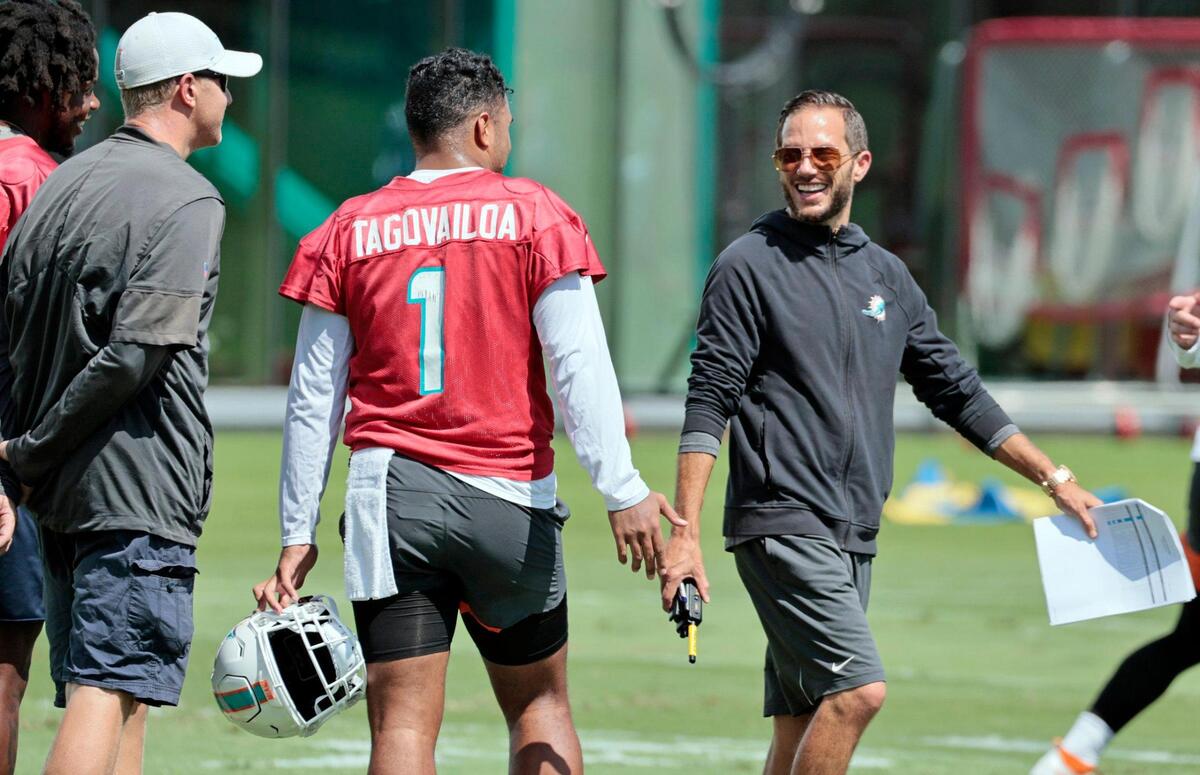 Miami Dolphins quarterback Tua Tagovailoa (1) and head coach Mike McDaniel interact during practice drills at Baptist Health Training Complex in Miami Gardens on Wednesday, October 12, 2022.