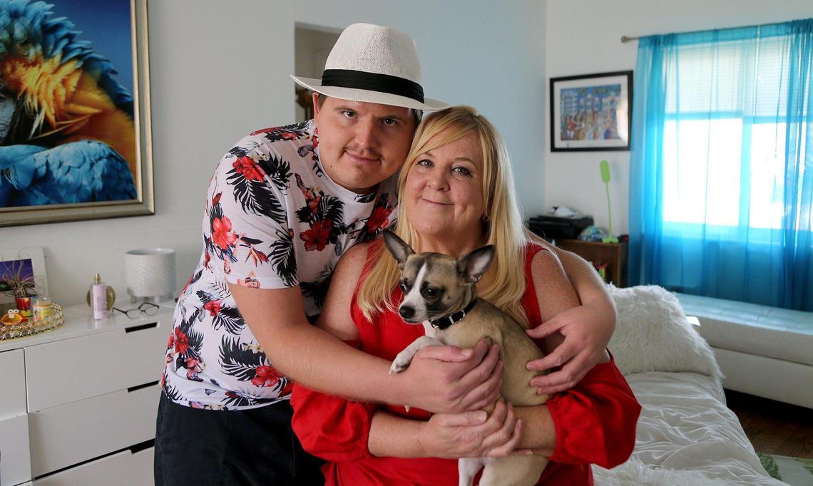 Tyler Borjas, 25, with his mother, Kelly Bain-Borjas, and his Chihuahua, Tito, at home Aug. 22, 2020.