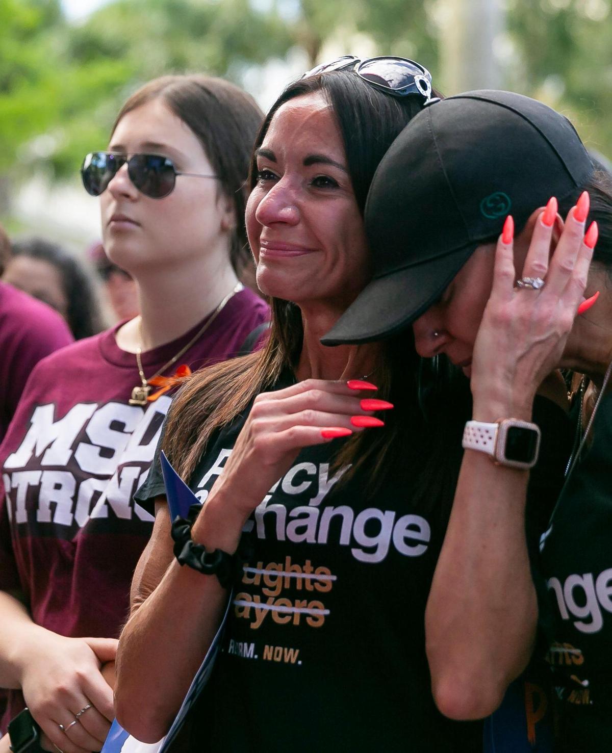 Tanya Welk, center, holds Corenna Smith as they participate in the March For Our Lives rally at Pine Trails Park on Saturday, June 11, 2022 in Parkland, Fla. One of the main goals of the rally is to increase pressure on politicians to pass laws that help prevent gun violence.