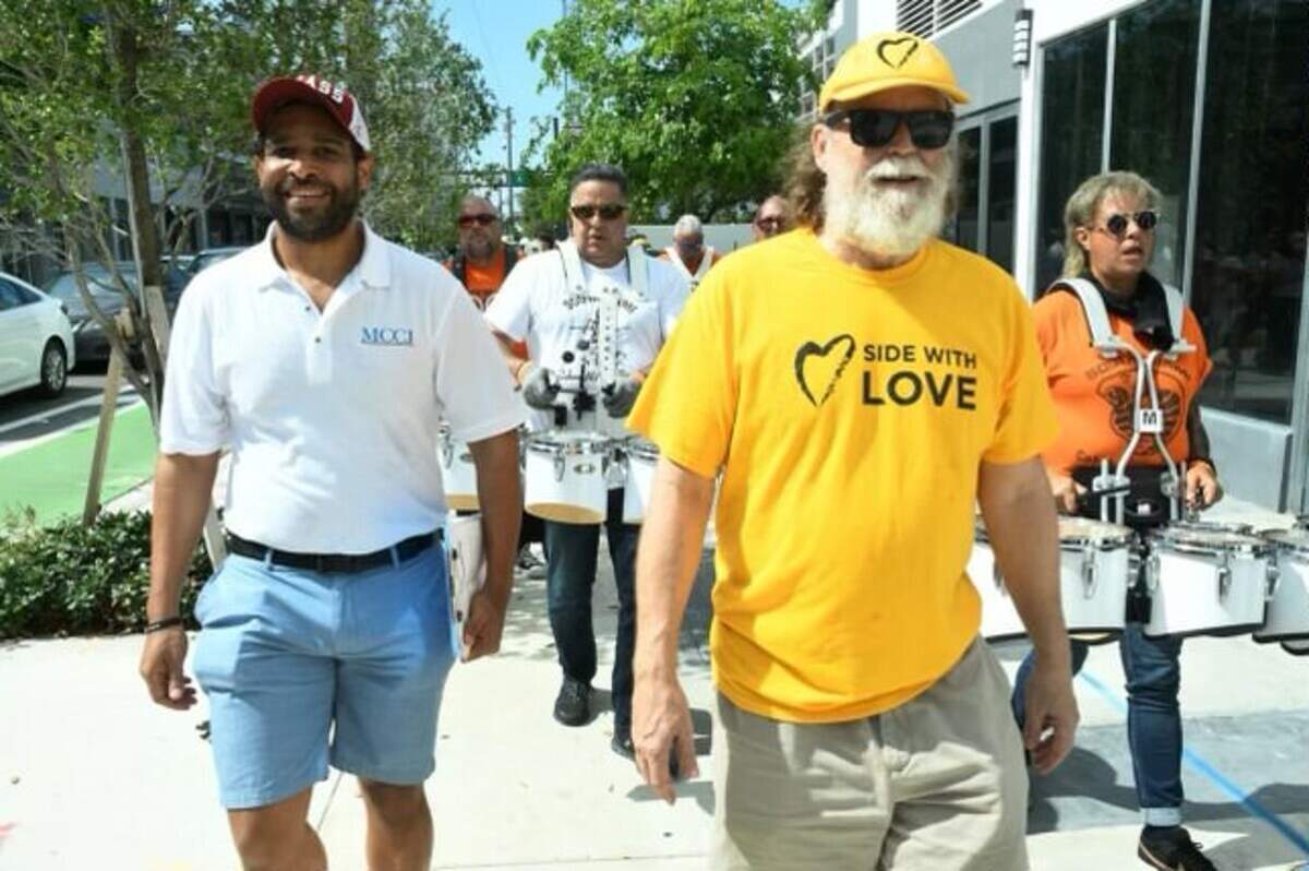 Matt Anderson, executive director of Mosaic Miami (left), walks next to Rev. Tom Capo, minister of the Unitarian Universalist Congregation of Miami, at the 2022 march for unity.
