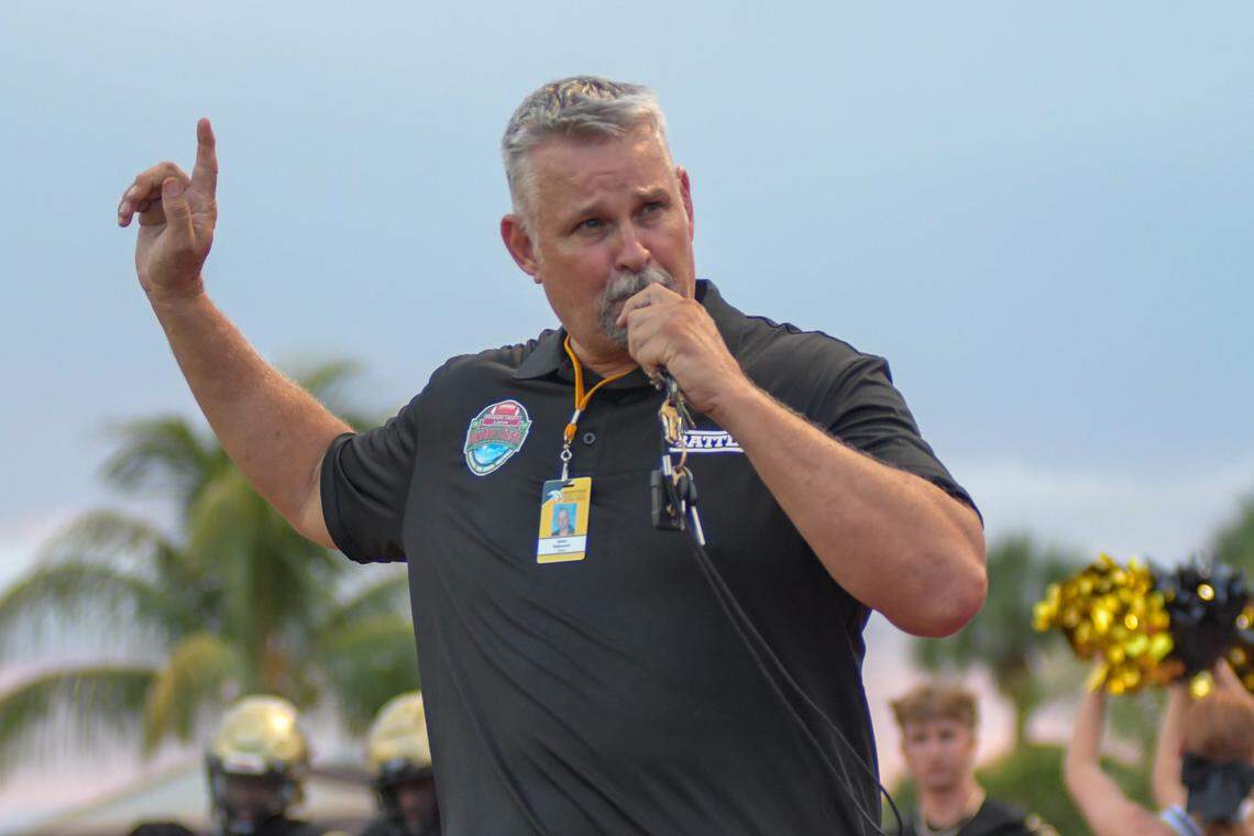 Western coach Adam Ratkevich leads the Wildcats to the field prior to their game against Johns Creek on Thursday, Aug. 25, 2022.