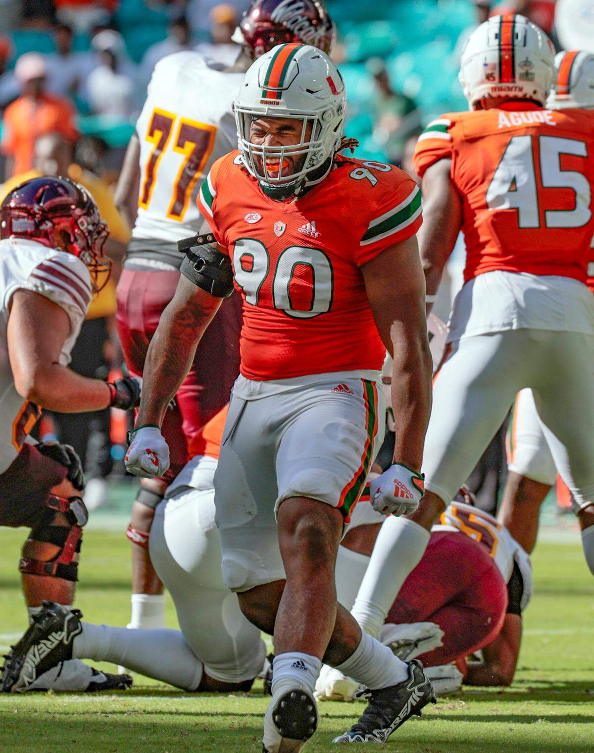 Miami Hurricanes defensive lineman Akheem Mesidor (90) reacts after tackling Bethune Cookman Wildcats quarterback Tyrone Franklin Jr (15) in the first half at Hard Rock Stadium in Miami Gardens on Saturday, September 3, 2022.