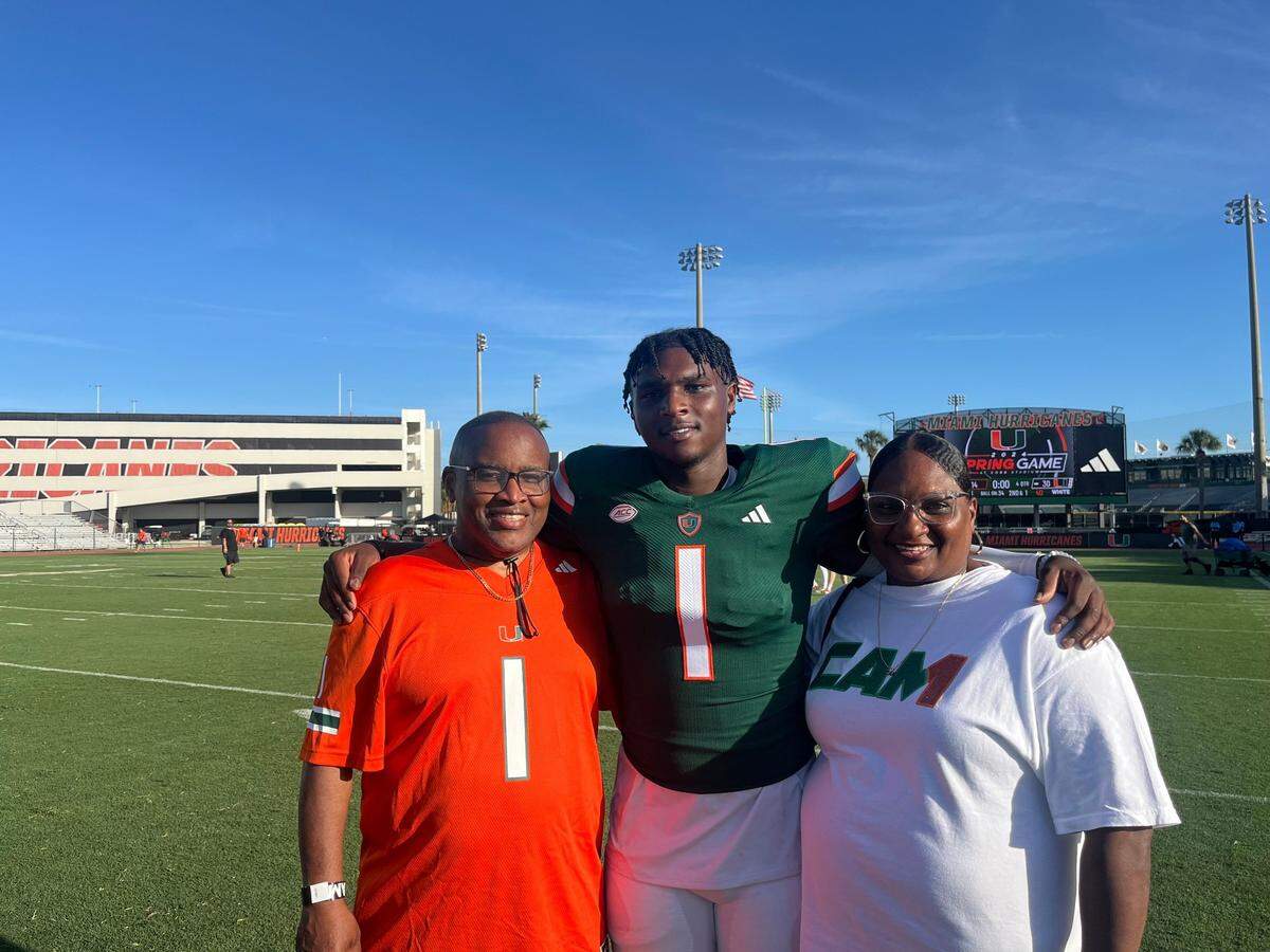 Miami Hurricanes quarterback Cam Ward (center) with parents Calvin Ward (left) and Patrice Ward (right) after the Hurricanes’ spring game.