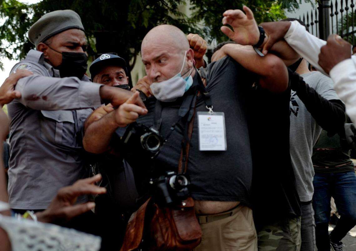 AP photographer Ramon Espinosa is arrested by the police while covering a demonstration against Cuban President Miguel Diaz-Canel in Havana, on July 11, 2021. - Thousands of Cubans took part in rare protests Sunday against the communist government, marching through a town chanting “Down with the dictatorship” and “We want liberty.” (Photo by Adalberto ROQUE / AFP) (Photo by ADALBERTO ROQUE/AFP via Getty Images)