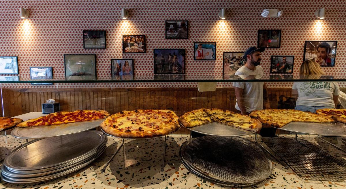 One wall inside Far Out Pizza is devoted to movie scenes in which a character is eating pizza.