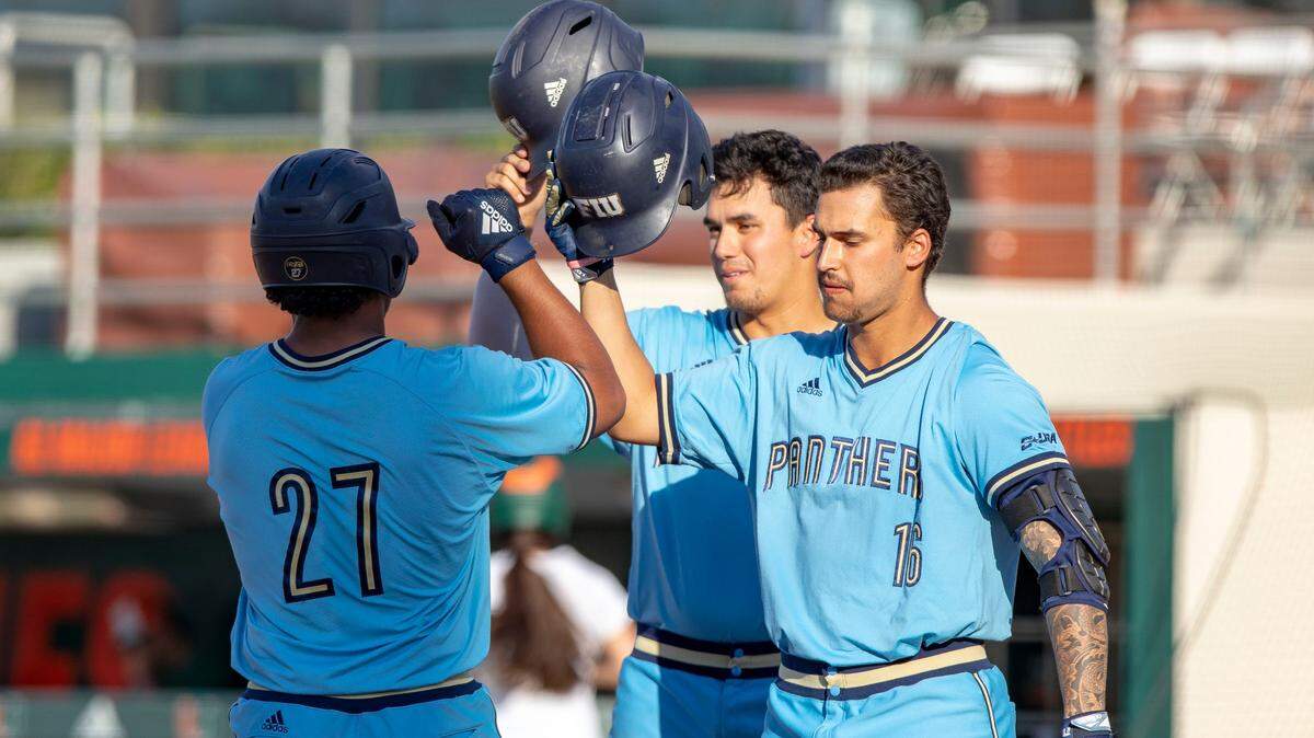 Florida International University catcher Jose Garcia (27) celebrates at home plate with his teammates Austin Shenton (6) and Javier Valdes (16) after hitting his ninth homer of the season during the first inning of a baseball game against University of Miami at Alex Rodriguez Park in Coral Gables, Florida, on Wednesday, April 24, 2019. Shenton and Valdes were both selected in this week’s MLB Draft.