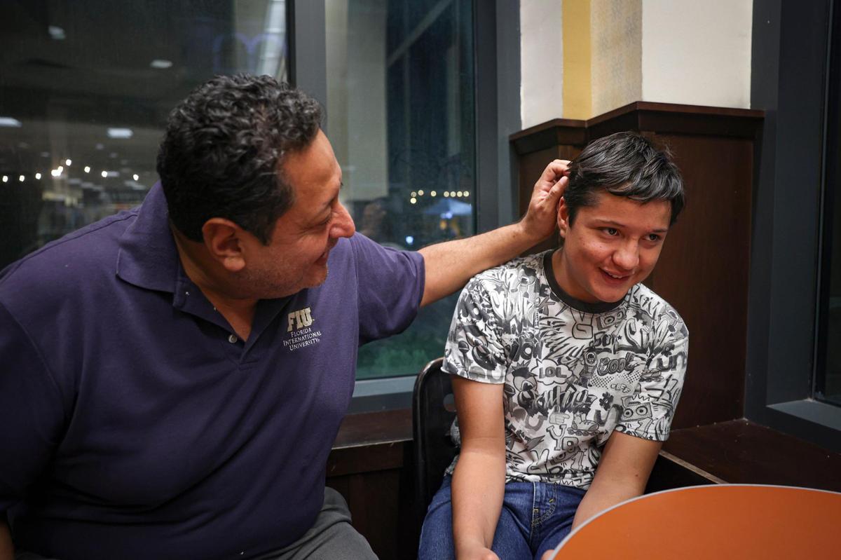 Adrian Gutierrez-Elbers, right, sits with his father, Danilo, in a bookstore on Monday, Dec. 6, 2022, in Pembroke Pines. He has a learning disability that affects his reading comprehension, so he is asking for a private tutor to help increase his reading level. He also enjoys researching marine biology and would love to get SCUBA certified so he can advance his interest in marine life.