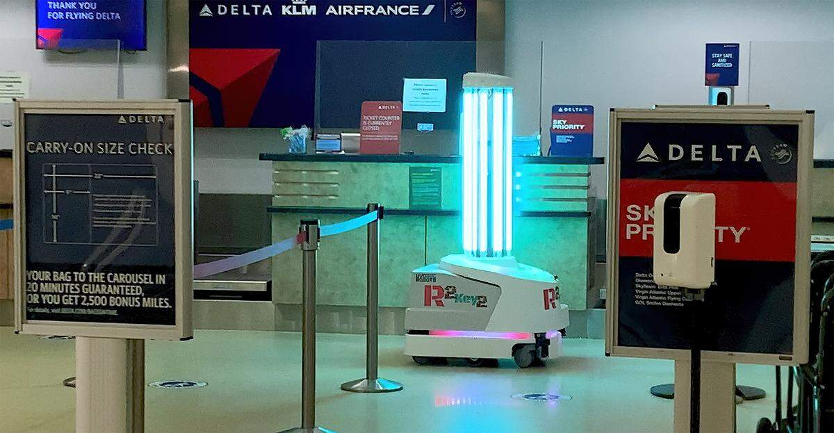 An ultraviolet light-emitting robot rolls in front of check-in counters at Key West International Airport on Feb. 2, 2021.