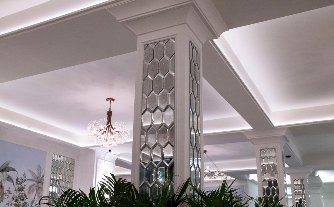 Mirrored glass and white paint at the Coral Gables Biltmore Hotel’s lower lobby covered up historic architectural features like filigreed stencils and warmer, historically authentic colors. City officials halted renovation work at the publicly-owned hotel after discovering it was being done without permits.