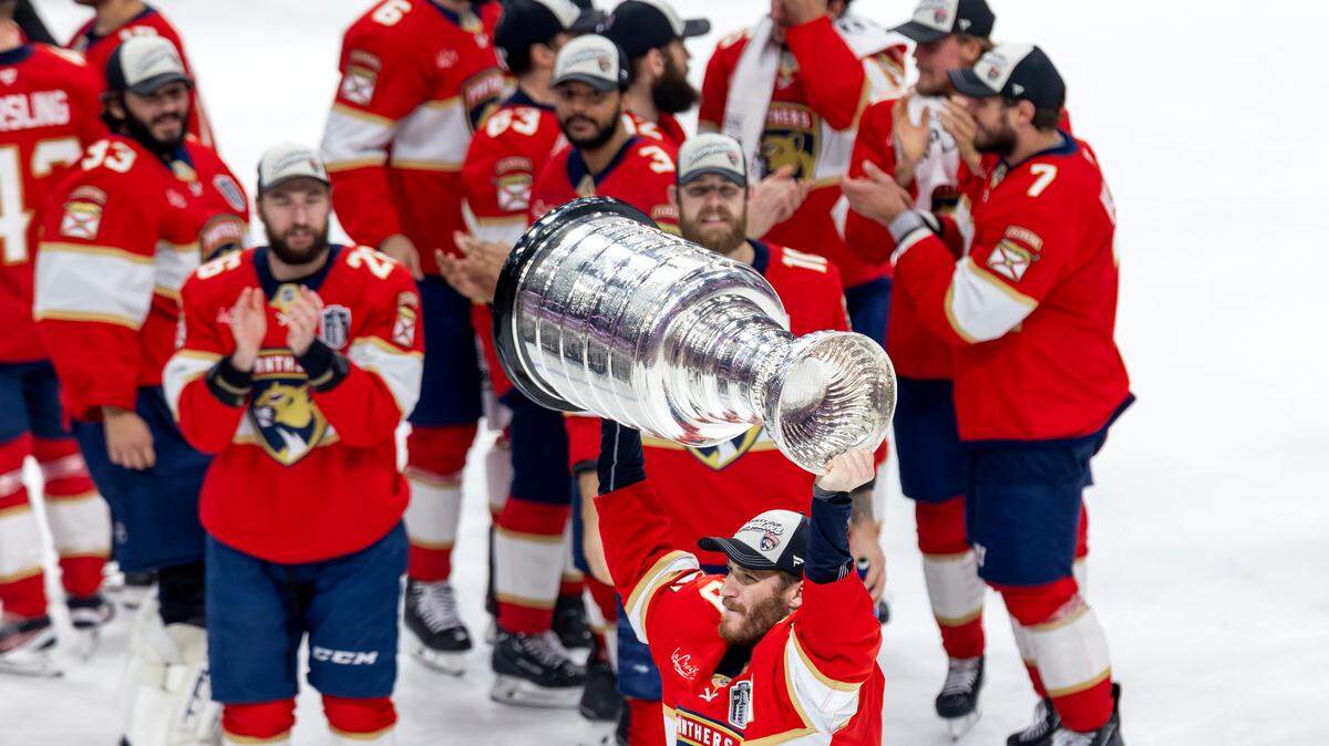 Florida Panthers left wing Matthew Tkachuk (19) lifts the Stanley Cup after defeating the Edmonton Oilers 5-1 in Game 6 of the Final at Amerant Bank Arena in Sunrise, Fla., on Tuesday, June 17, 2025, clinching the NHL championship.