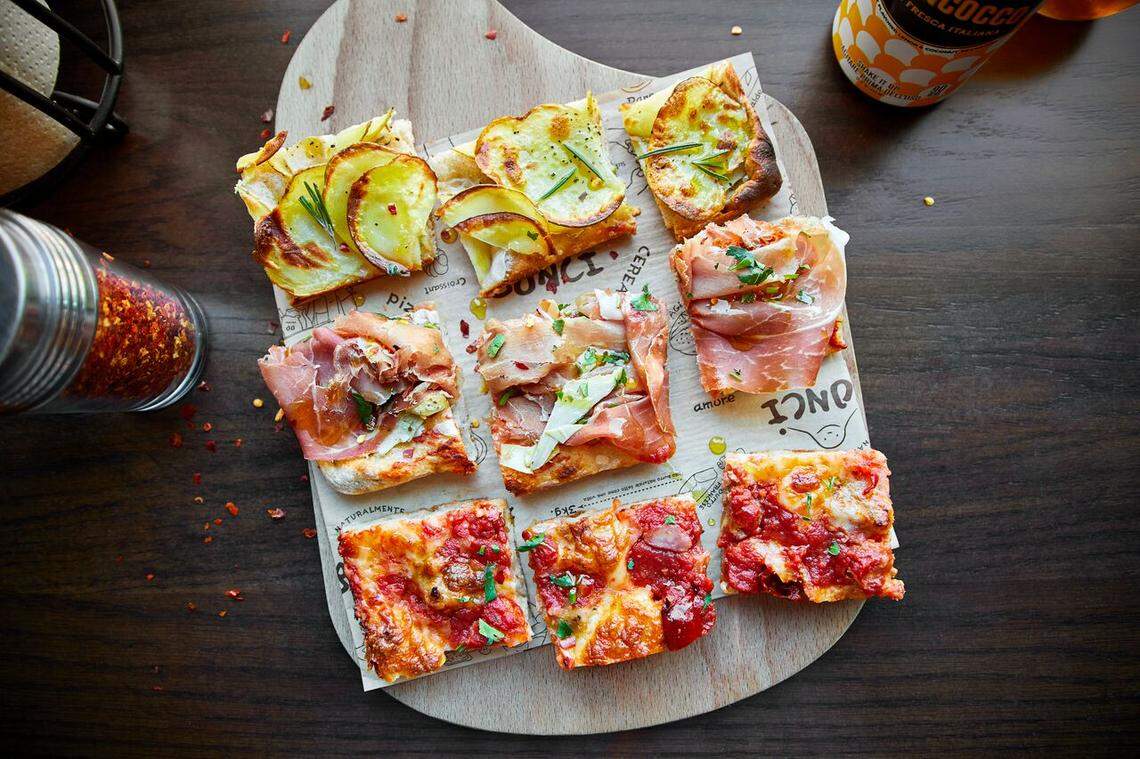 The pizza is cut into squares and sold by the pound at Bonci.