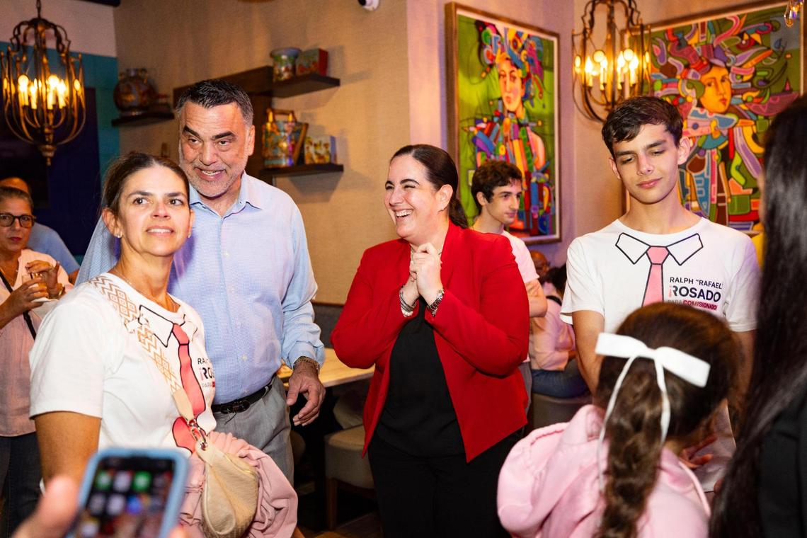 Victoria Méndez, former Miami city attorney, center, congratulates Ralph Rosado’s wife, Mari, left, and his family during Rosado’s watch party on Tuesday, June 3, 2025, at El Atlacatl restaurant in Miami.