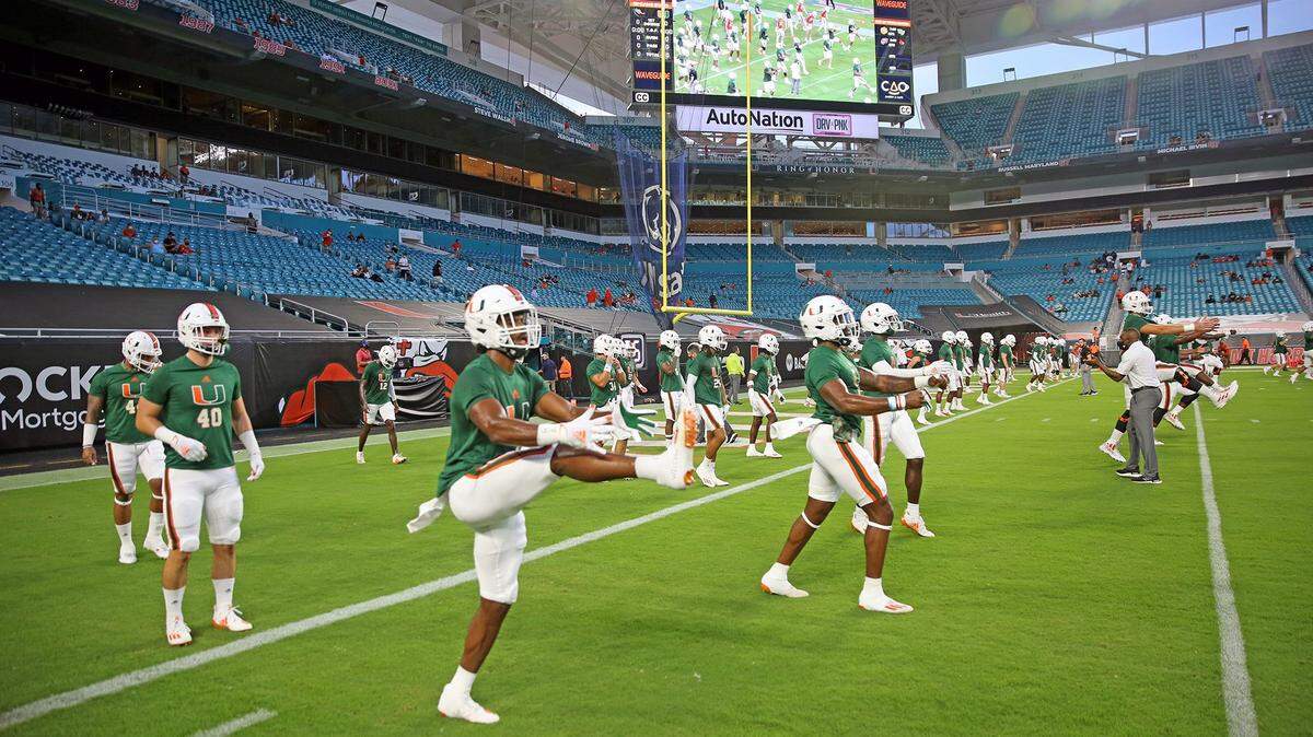 Hurricane players warm up as fans arrive as the University of Miami hosts the UAB Blazers at Hard Rock Stadium in Miami Gardens on Thursday, September 10, 2020.