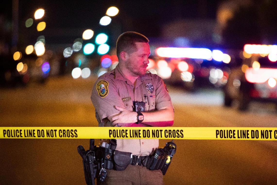 Miami-Dade Police work a crime scene around Northwest 62nd Street and Seventh Avenue in Miami, Florida, on Monday, Aug. 15, 2022. A Miami-Dade police officer was shot after a car chase in Liberty City on Monday night, multiple law-enforcement sources said.