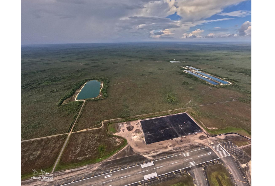Aerial photography shows an 11-acre patch of new asphalt at Alligator Alcatraz. Environmental groups have threatened to sue.