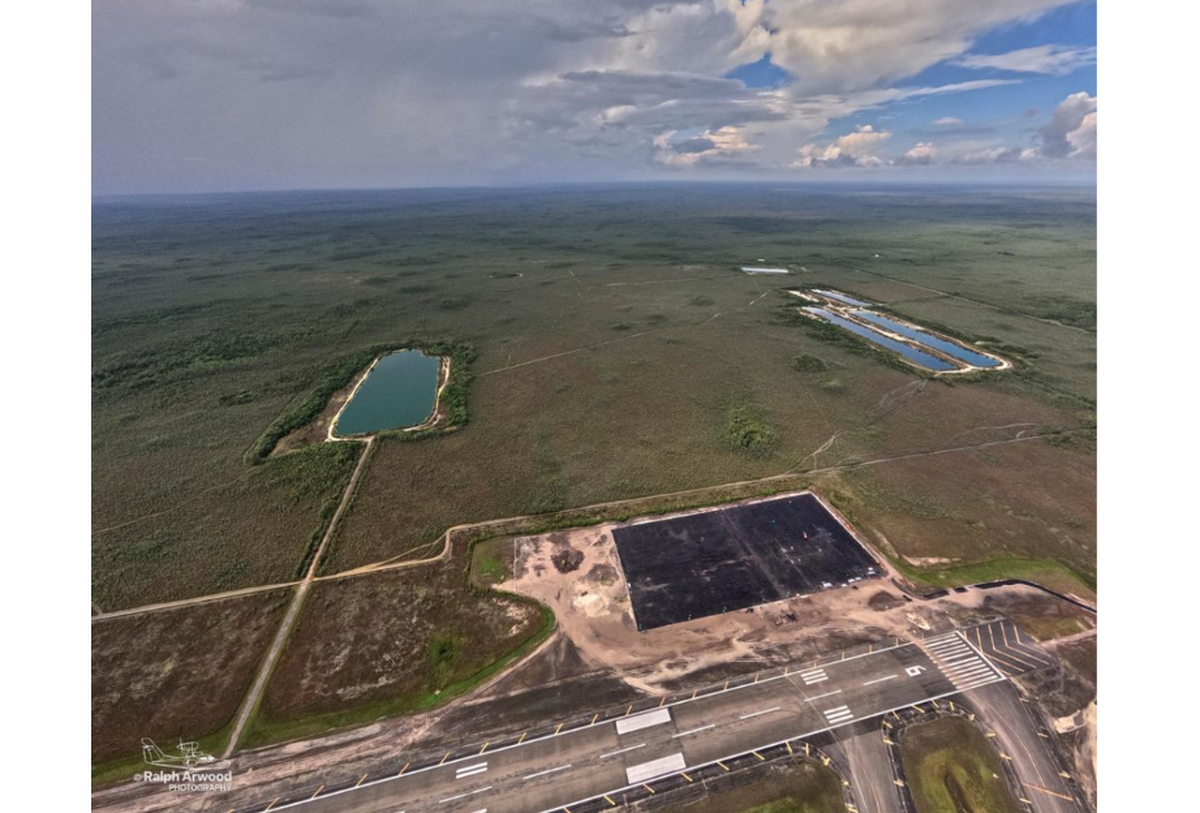 Aerial photography shows an 11-acre patch of new asphalt at Alligator Alcatraz. Environmental groups have threatened to sue.