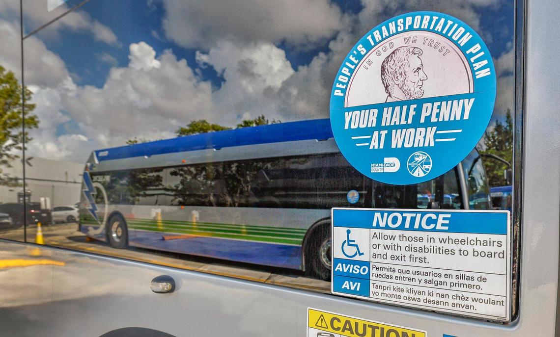 “Your half penny at work” sticker on broken electric Proterra buses parked at Miami-Dade County Coral Way Bus Maintenance Facility in Miami on Wednesday, February 19, 2025.