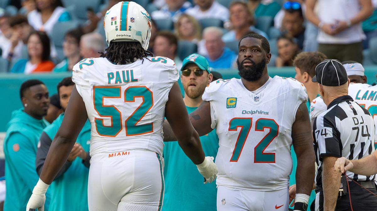 Miami Dolphins offensive tackle Terron Armstead (72) high five teammate Patrick Paul (52) after a play in the second half of their NFL game against the New England Patriots at Hard Rock Stadium on Sunday, Nov. 24, 2024, in Miami Gardens, Fla