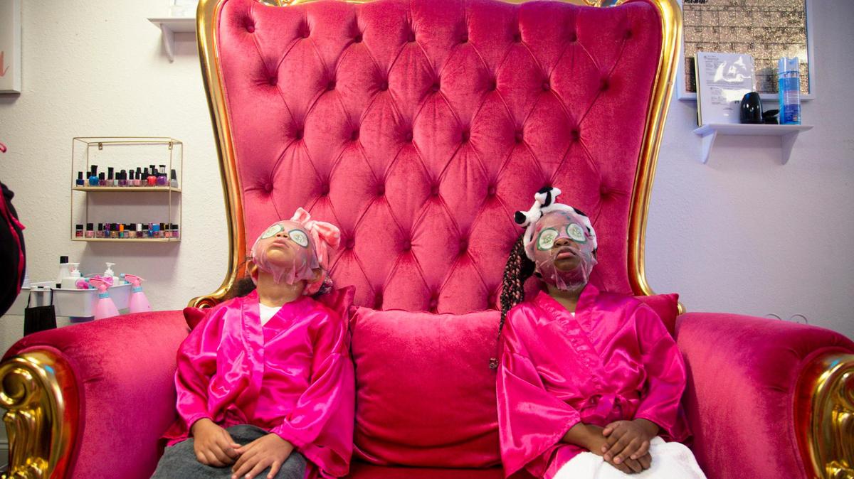 Mellani Cooper Garcia, 6, and Dezneiy Boyd, 7, relax sitting on a couch while getting facials as part of their Princess Spa Experience at Lollipops & Gumdrops Children’s Spa located at 1119 NW Third Ave. in the neighborhood of Overtown in Miami, Florida, on Wednesday, July 14, 2021.