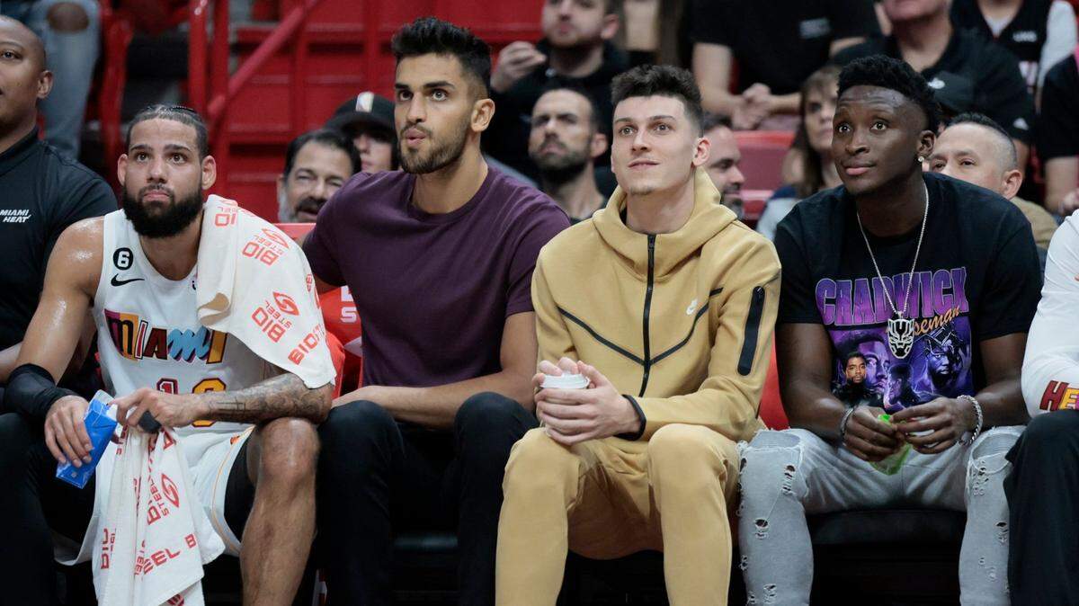 From the bench, Miami Heat forward Caleb Martin (16) center Omer Yurtseven (77), guard Tyler Herro (14) and guard Victor Oladipo (4) watch the game against the Charlotte Hornets in the second half at FTX Arena in Miami on Saturday, November 12, 2022.