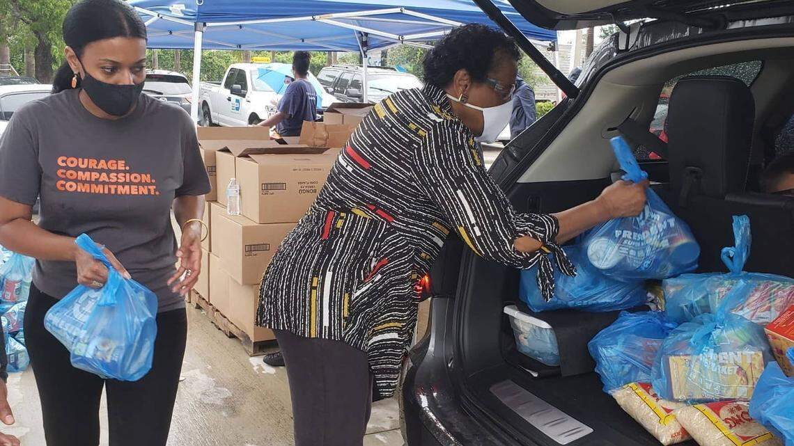 Kerry-Ann Royes, president and CEO of YWCA South Florida, left, and retired District 1 Commissioner Barbara Jordan help with food distribution at the YWCA in Miami Gardens. The YWCA is one of the beneficiaries of The Miami Foundation’s Racial Equity Fund.