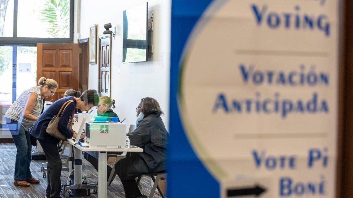 Voters are helped by election officials during early in-person voting at the Coral Gables Library on Monday, March 4, 2024, in Coral Gables, Fla.