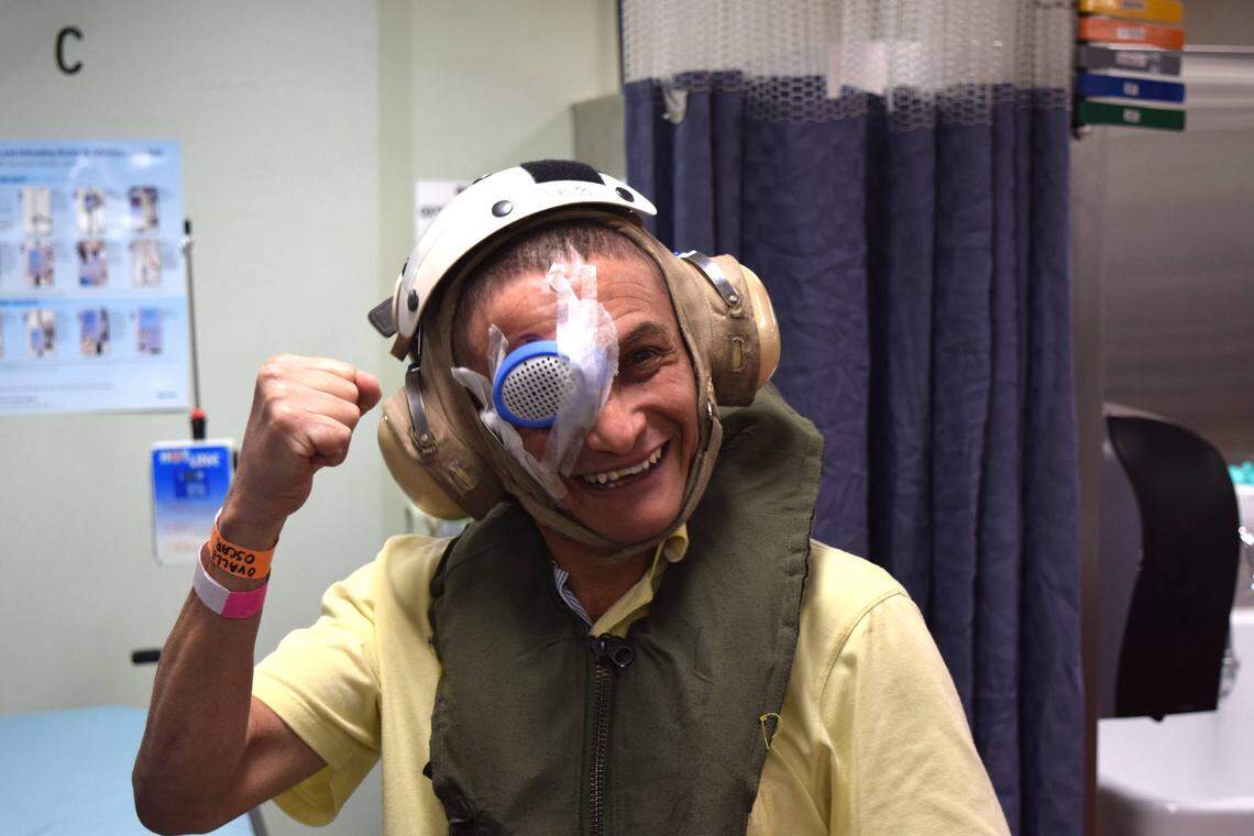 Oscar Ovalle, 59, dons flight headgear  after getting cataract surgery aboard the USNS Comfort, a U.S. medical ship off the coast of Riohacha, Colombia, this week. The ship is floating 15 miles off the coast, near the border with Venezuela, and is only accessible by helicopter.