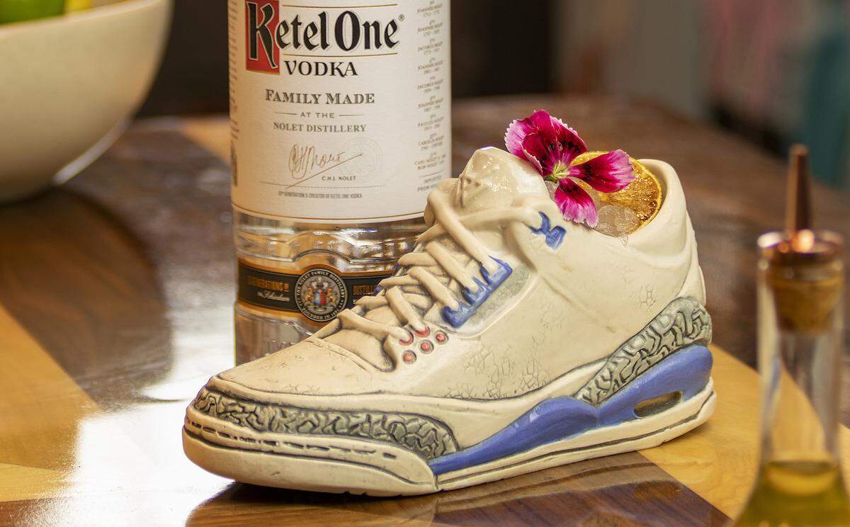 The Satisfy Your Sole cocktail is featured in a ceramic replica of a Nike Air Jordan 3 at the sneaker-themed Grails sports bar in Wynwood.