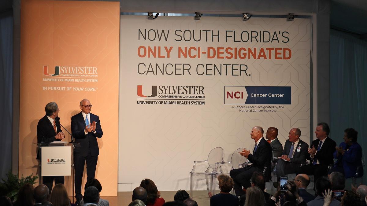 UM president, Julio Frank, left, with the director of Sylvester Comprehensive Cancer Center, Stephen D. Nimer, at his side turns after the Sylvester Comprehensive Cancer Center, part of the University of Miami Leonard M. Miller School of Medicine, announced its prestigious NCI designation from the National Cancer Institute on Monday, July 29, 2019.