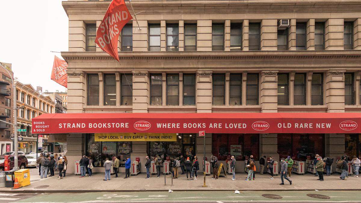 Shoppers wait to enter the Strand bookstore in Manhattan on Sunday, Oct. 25. People lined up outside the New York bookstore after its owner announced on social media that its revenue was down nearly 70 percent from last year and that the business had become unsustainable due to the pandemic. “With many businesses facing tough choices right now, finding new ways to tap into customer loyalty and secure new clients, while keeping people comfortable doing business with you, is critical to survival and success,” says James S. Cassel..