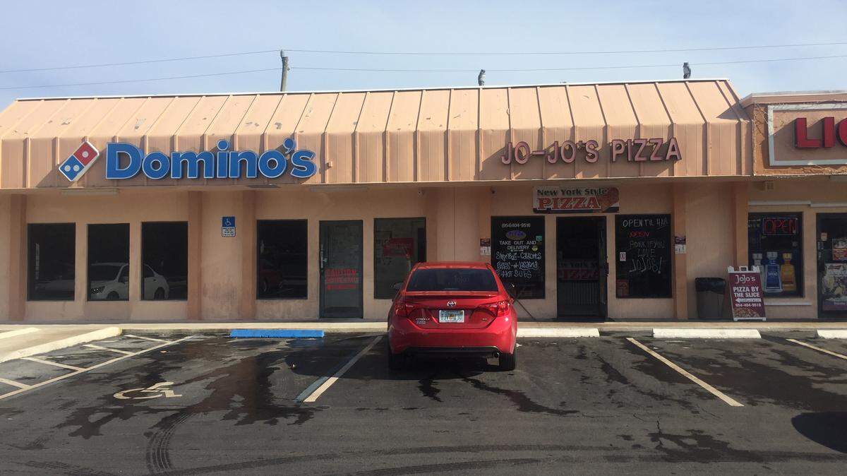 The two pizzerias of Hollywood's Oakwood Plaza Shops. JoJo's and Domino's share a wall and, occasionally, parking spaces to the dismay of JoJo's owners.