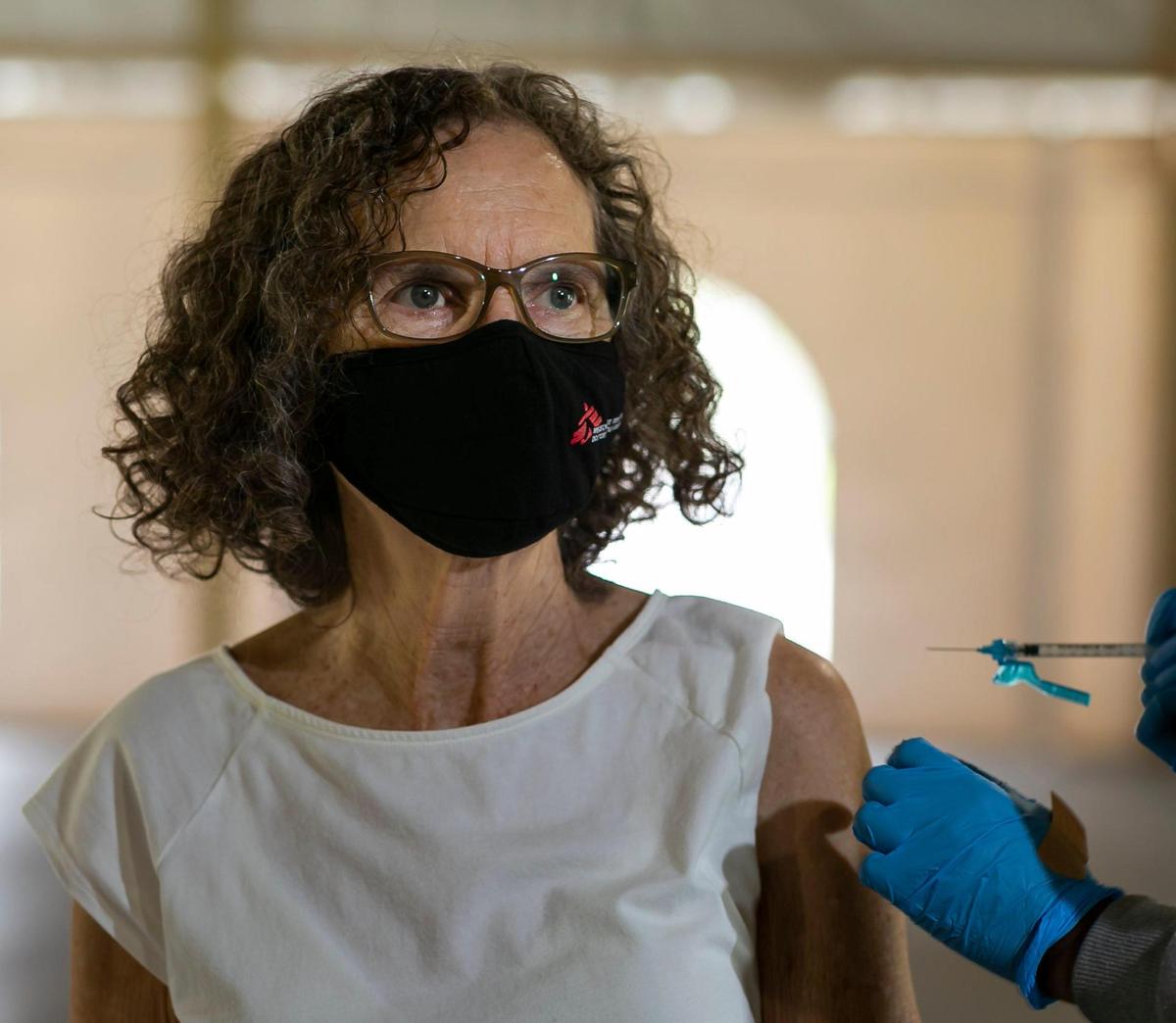 Christine Barkett receives her third shot of the Pfizer-BioNTech COVID-19 vaccine at C.B. Smith Park in Pembroke Pines, Florida on Friday, October 8, 2021.