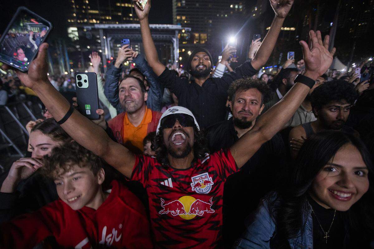 People react to music during New Year’s Eve celebrations at Bayfront Park in Miami.