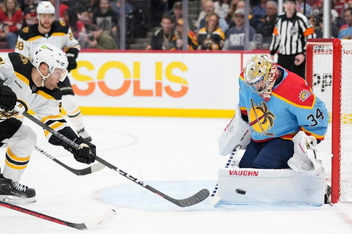 Boston Bruins left wing Taylor Hall, left, attempts a shot at Florida Panthers goaltender Alex Lyon (34) during the first period of an NHL hockey game, Saturday, Jan. 28, 2023, in Sunrise, Fla. (AP Photo/Wilfredo Lee)