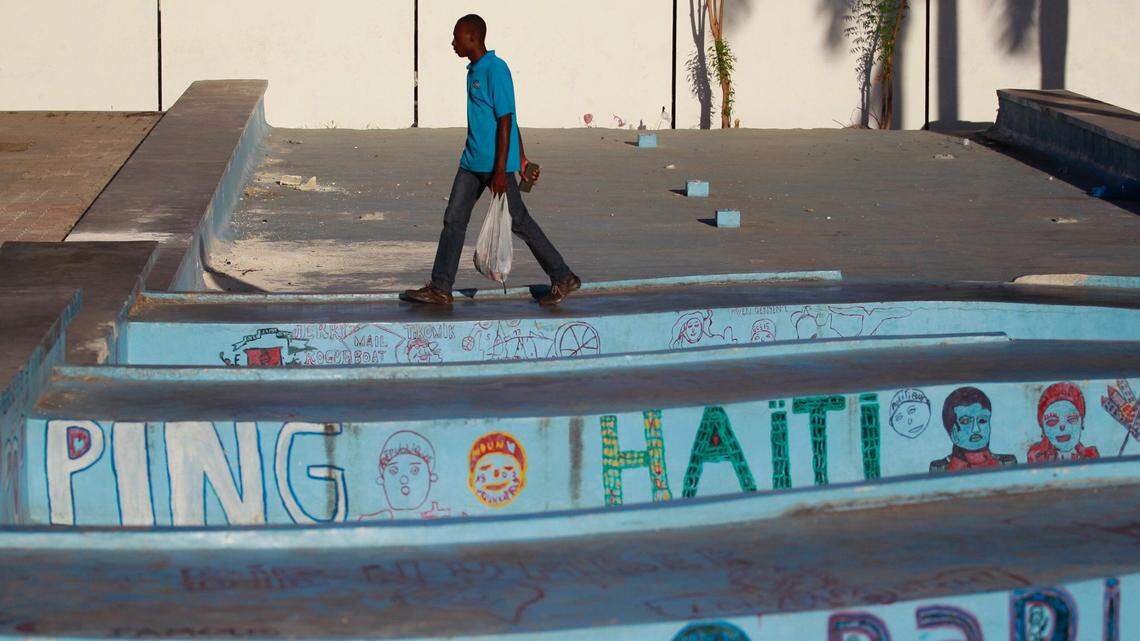 A Haitian man makes his way through the plaza near the National Palace as street life was slowly returning on Tuesday, Feb. 19, 2019 in Port-au-Prince, Haiti.