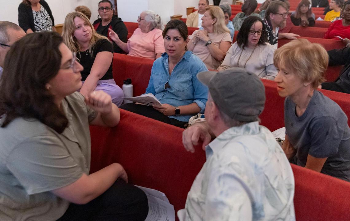 Doris Galindo, center, a member of Temple Beth Sholom, meets with her congregation during an annual meeting with the interfaith nonprofit PACT (People Acting for Community Together). PACT announced that their new campaign for the year will focus on combating rent and homelessness in Miami-Dade County.